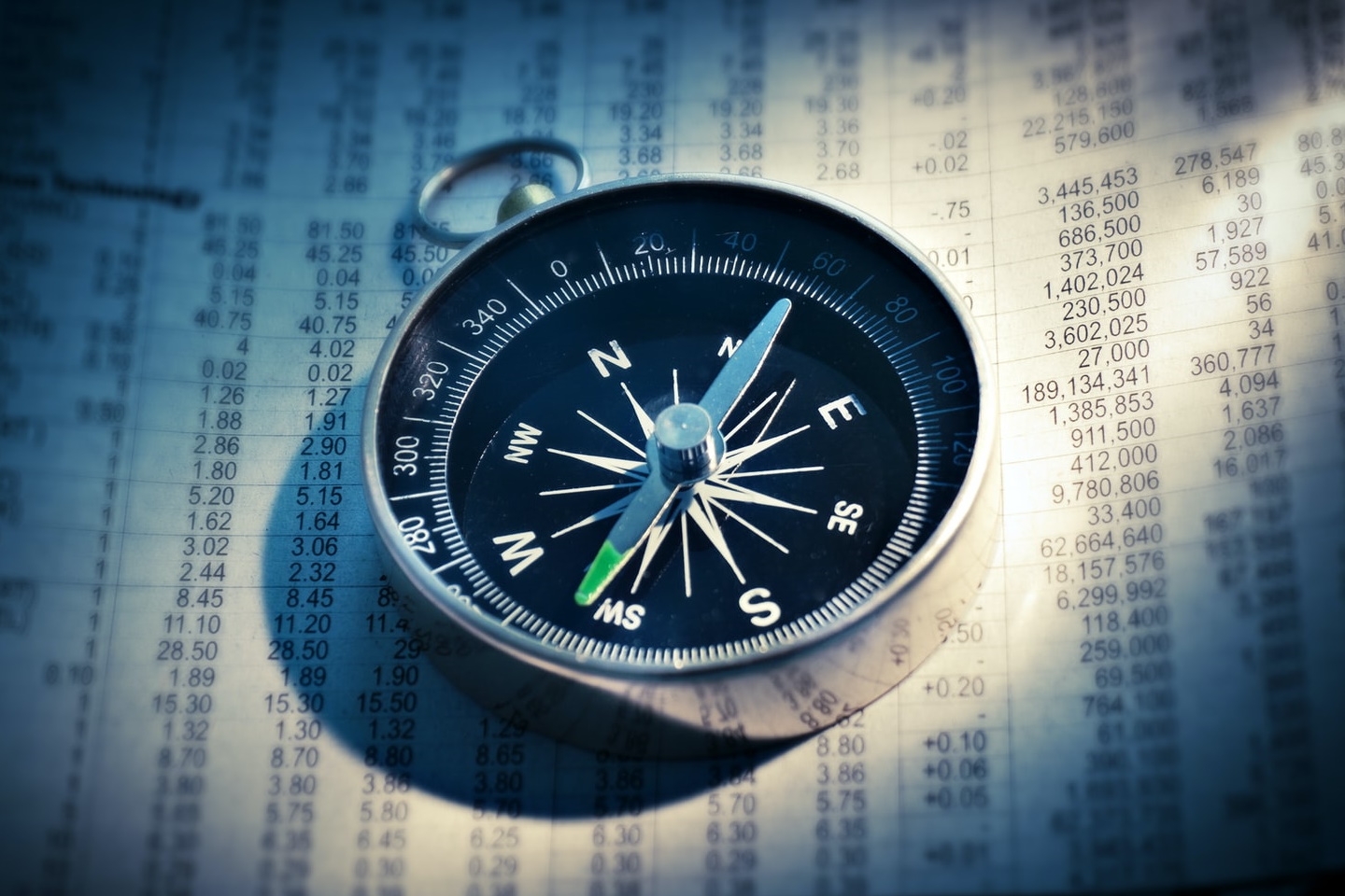 A compass over a spreadsheet